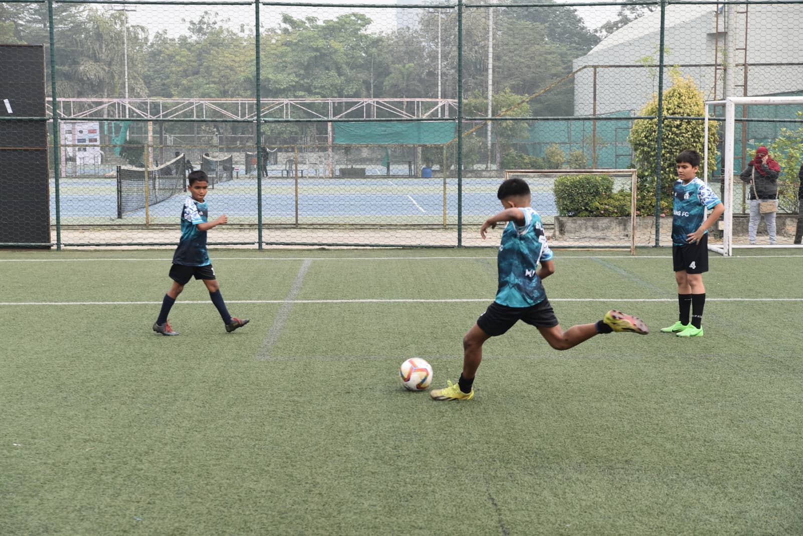 NVIANS FC player striking the ball during a youth football tournament